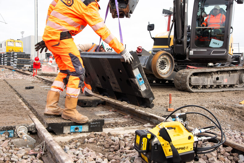 Crane lowering StrandLock panel into position on the track